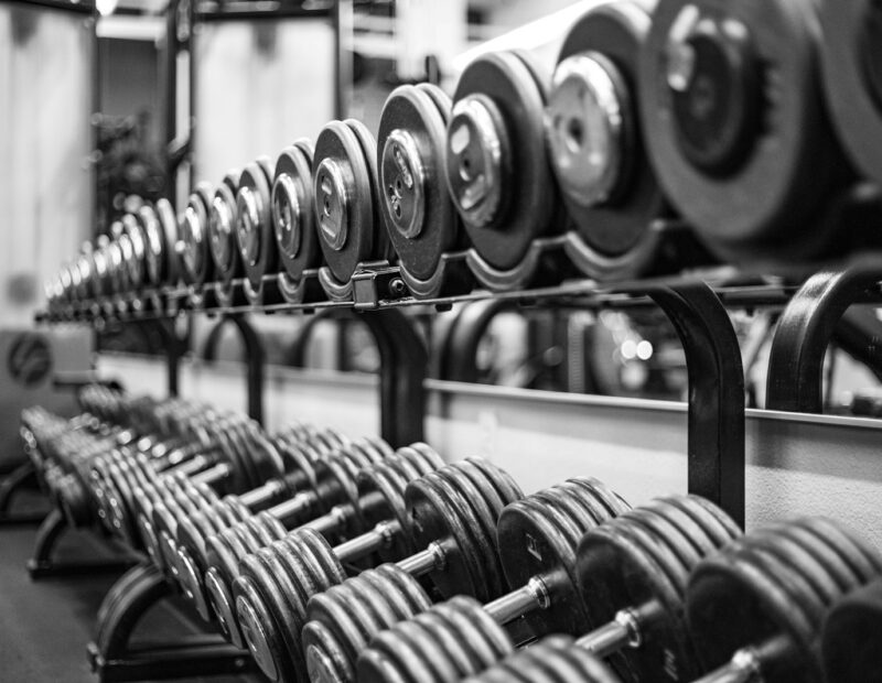 gray scale photo of dumbbells