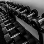 black and silver dumbbells on black steel rack