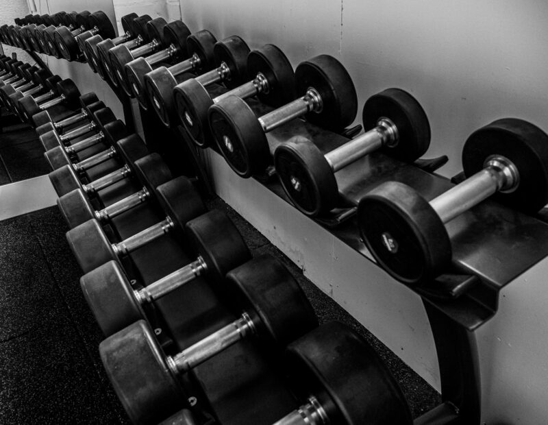 black and silver dumbbells on black steel rack