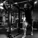 a man is doing a pull up in a gym